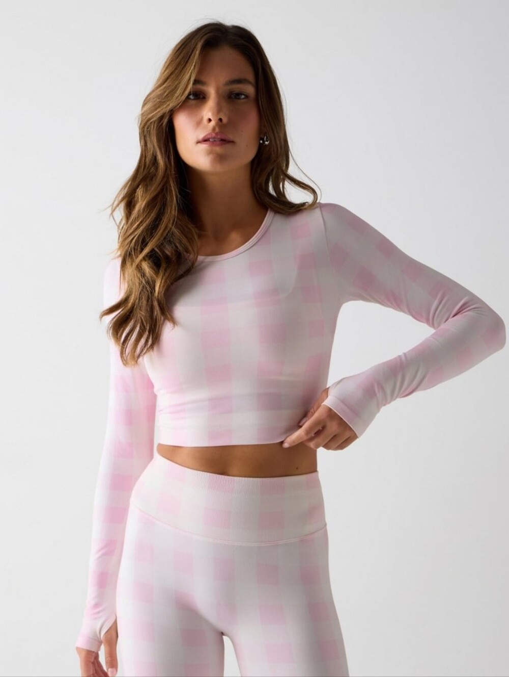 Fabletics Sleek Seamless Long-Sleeve Top in a soft pink buffalo check pattern